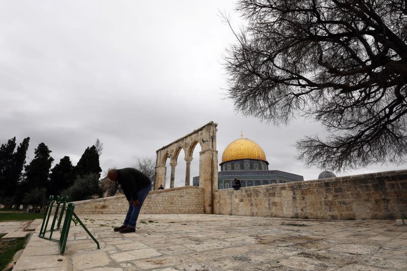 A worshipper prays in front of the Dome of the Rock in the compound known to Muslims as Noble Sanctuary and to Jews as Temple Mount, in Jerusalem's Old City