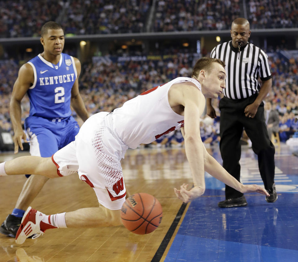 Wisconsin forward Sam Dekker tries to save the ball from going out against Kentucky during the first half of the NCAA Final Four tournament college basketball semifinal game Saturday, April 5, 2014, in Arlington, Texas. (AP Photo/Eric Gay)