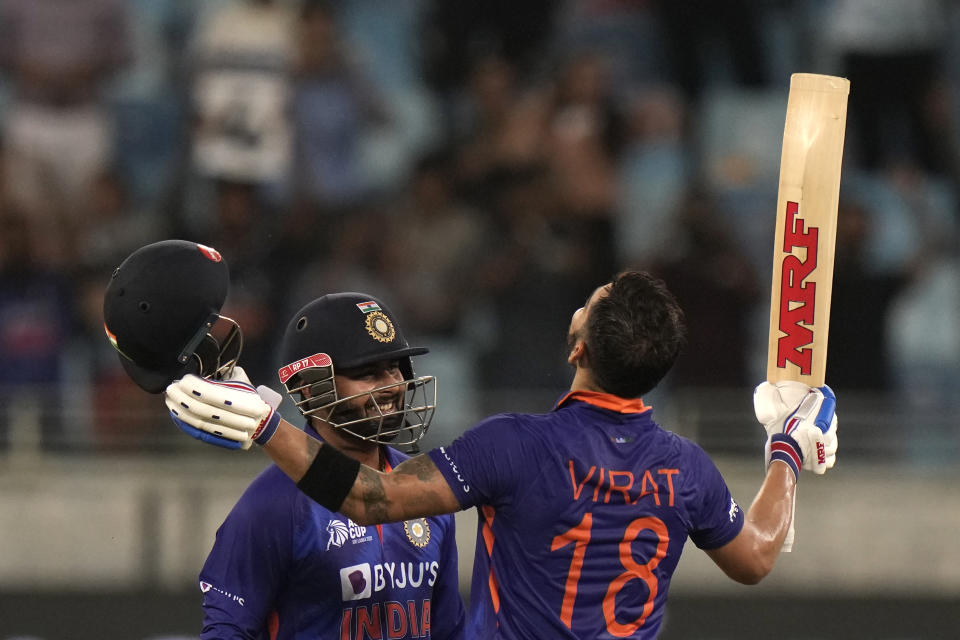 India's Rishabh Pant, left, watches as batting partner Virat Kohli celebrates scoring a century during the T20 cricket match of Asia Cup between India and Afghanistan, in Dubai, United Arab Emirates, Thursday, Sept. 8, 2022. (AP Photo/Anjum Naveed)