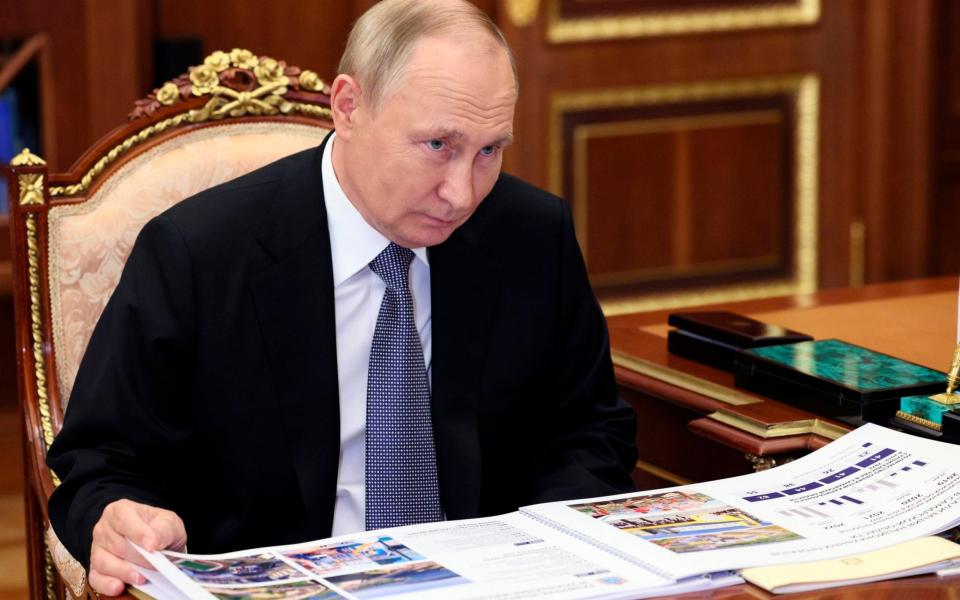 Russian President Vladimir Putin listens to Samara Region Governor Dmitry Azarov during their meeting in Moscow. - Gavriil Grigorov/AP