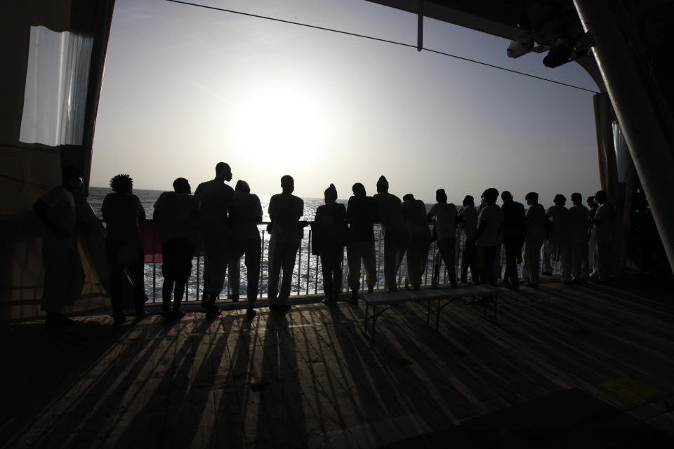 African migrants look at the Mediterranean Sea as they await disembarkation at the port of Augusta, on the island of Sicily, Italy, Monday, Sept. 27, 2021. The migrants say they were tortured and their families extorted for ransoms in Libya’s detention centers. (AP Photo/Ahmed Hatem)