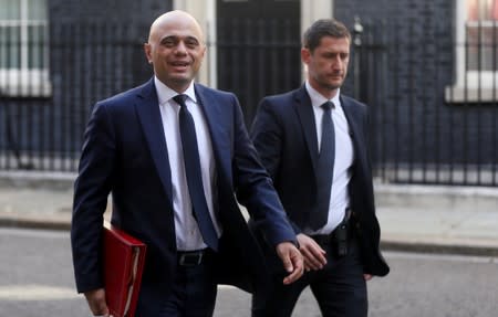 Britain's Chancellor of the Exchequer Sajid Javid walks outside Downing Street in London