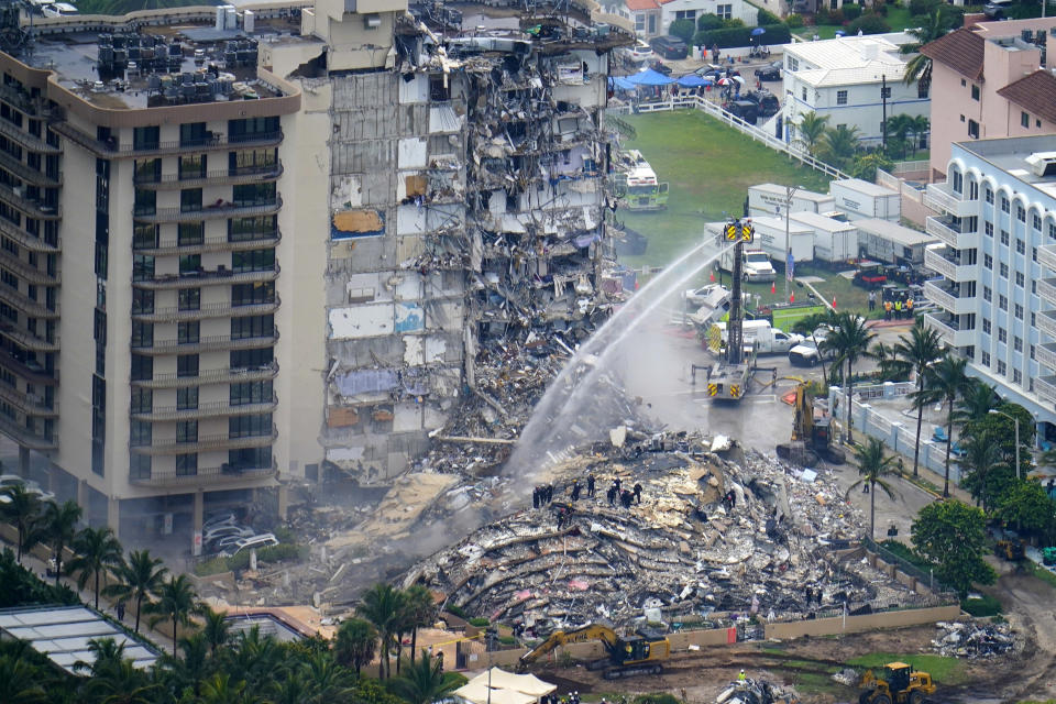 FILE - Rescue personnel work at the remains of the Champlain Towers South condo building, June 25, 2021, in Surfside, Fla. The probe into the 2021 collapse of the beachfront condominium building that killed 98 people in South Florida should be completed by the fourth anniversary of the disaster, federal officials said Thursday, Sept. 7, 2023. (AP Photo/Gerald Herbert, File)