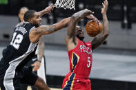 New Orleans Pelicans guard Eric Bledsoe (5) is blocked by San Antonio Spurs center LaMarcus Aldridge (12) as he tries to score during the first half of an NBA basketball game in San Antonio, Saturday, Feb. 27, 2021. (AP Photo/Eric Gay)