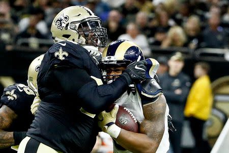 Nov 27, 2016; New Orleans, LA, USA; New Orleans Saints defensive tackle Nick Fairley (90) tackles Los Angeles Rams running back Todd Gurley (30) for a loss during the fourth quarter of a game at the Mercedes-Benz Superdome. Mandatory Credit: Derick E. Hingle-USA TODAY Sports