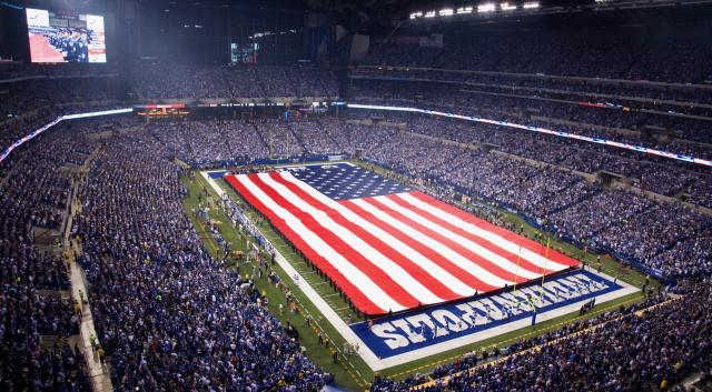 United States flags fly in center field before a baseball game