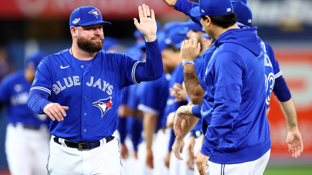 Toronto Blue Jays manager John Schneider, right, laughs as he