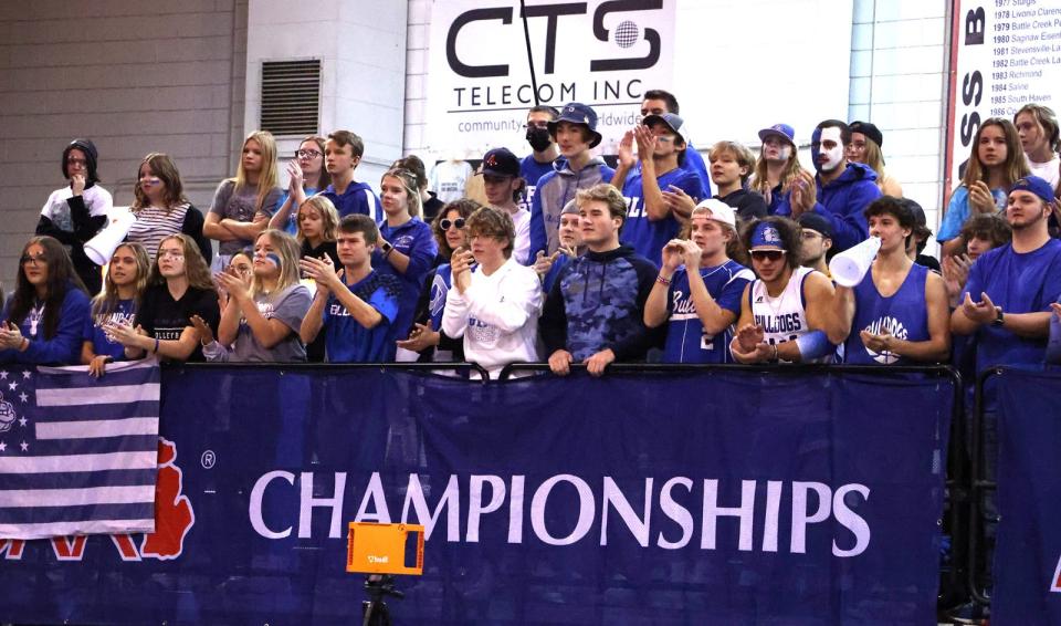 The Inland Lakes student section cheers on the volleyball team during their state championship contest against Battle Creek St. Philip on Saturday.