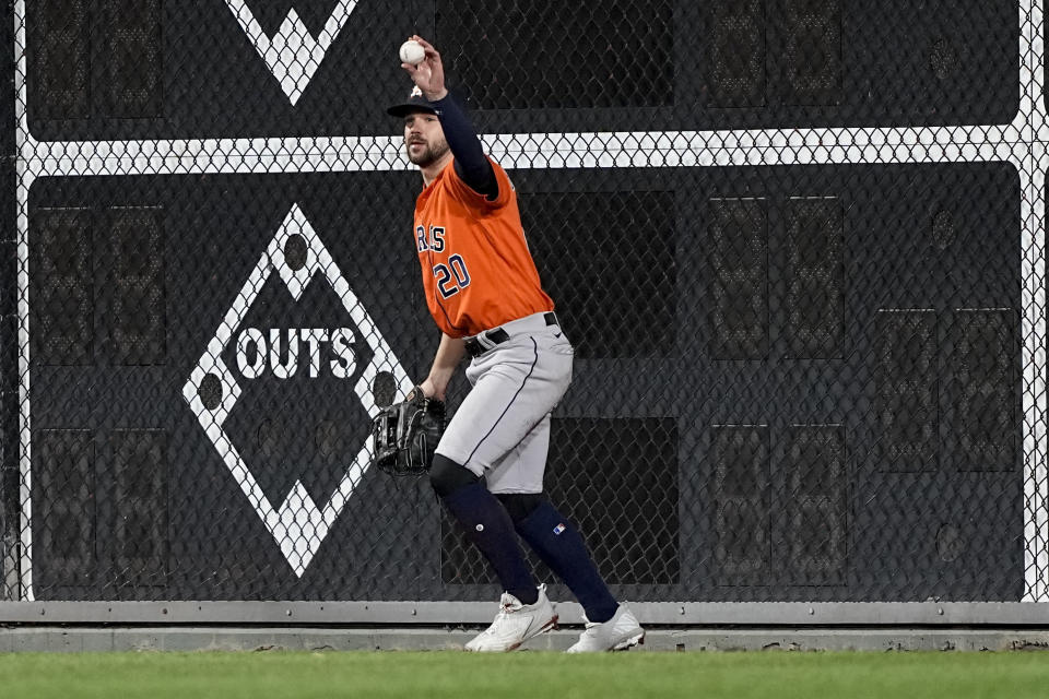 Houston Astros left fielder Chas McCormick celebrates his catch of a fly ball hit by Philadelphia Phillies' J.T. Realmuto during the ninth inning in Game 5 of baseball's World Series between the Houston Astros and the Philadelphia Phillies on Thursday, Nov. 3, 2022, in Philadelphia. The Houston Astros won 3-2. (AP Photo/David J. Phillip)