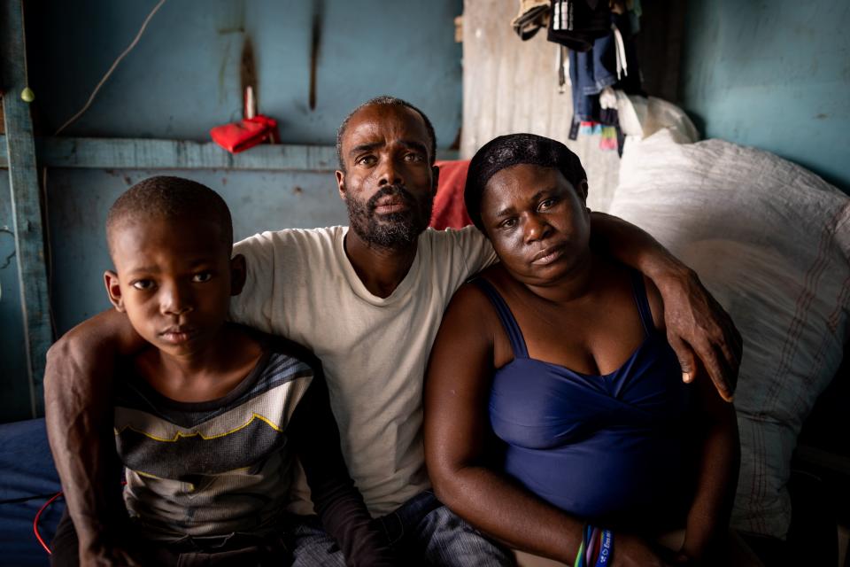 Marie Sonise Zare, 48, her son, Peni Jameda, 9, and her husband, Michelet Cedor, 44, keep a bag packed and ready to go in their home in Batey Libertad, with hopes to return to Haiti. | Spenser Heaps, Deseret News