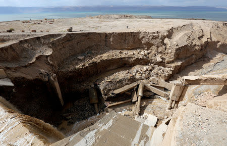 FILE PHOTO: Civil defense members look for survivors after rain storms unleashed flash floods near the Dead Sea, Jordan October 26, 2018. REUTERS/Muhammad Hamed/File Photo