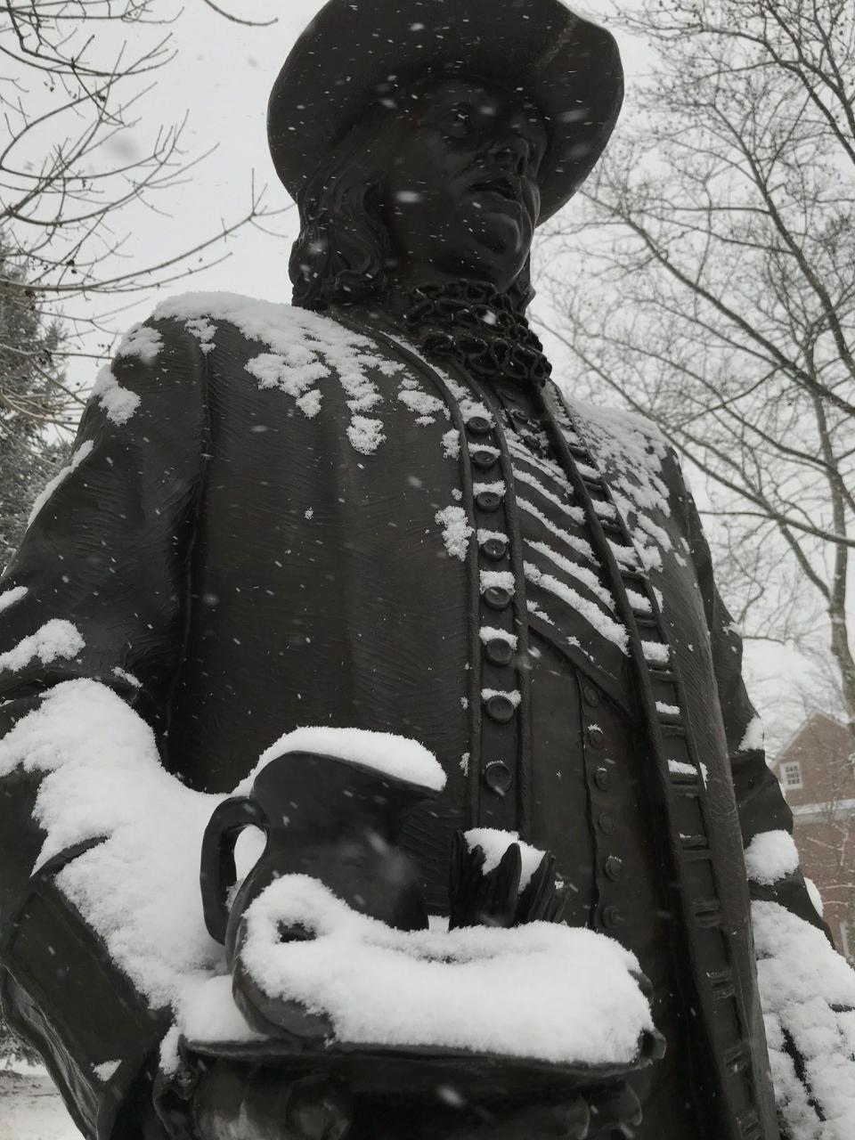 The statue of William Penn gets a light coating of snow on it Wednesday afternoon in Old New Castle.