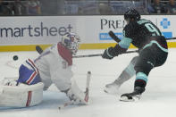 Seattle Kraken center Ryan Donato (9) scores a goal past Montreal Canadiens goaltender Jake Allen, left, during the third period of an NHL hockey game, Tuesday, Oct. 26, 2021, in Seattle. The Kraken won 5-1. (AP Photo/Ted S. Warren)