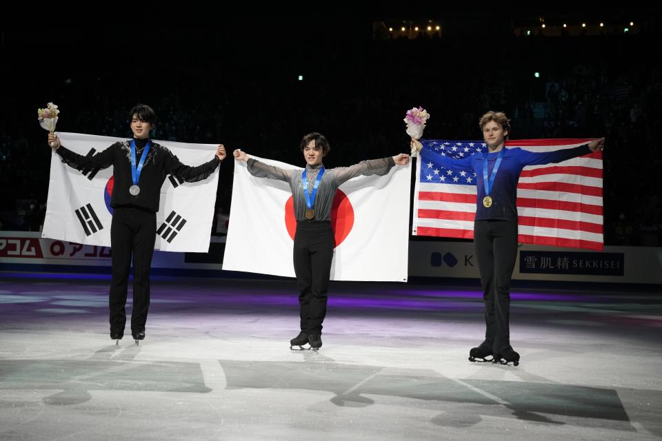 Shoma Uno of Japan, center, with his gold medal, Cha Junhwan of South Korea, left, with his silver medal, and Ilia Malinin of the U.S., with his bronze medal, pose for a photo at the end of the award ceremony for the men's free skating in the World Figure Skating Championships in Saitama, north of Tokyo, Saturday, March 25, 2023. (AP Photo/Hiro Komae)