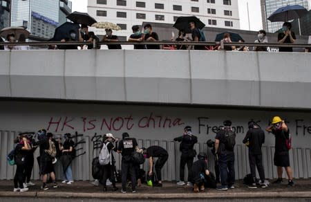 Demonstrators get ready to clash with police as they attend a protest in Hong Kong