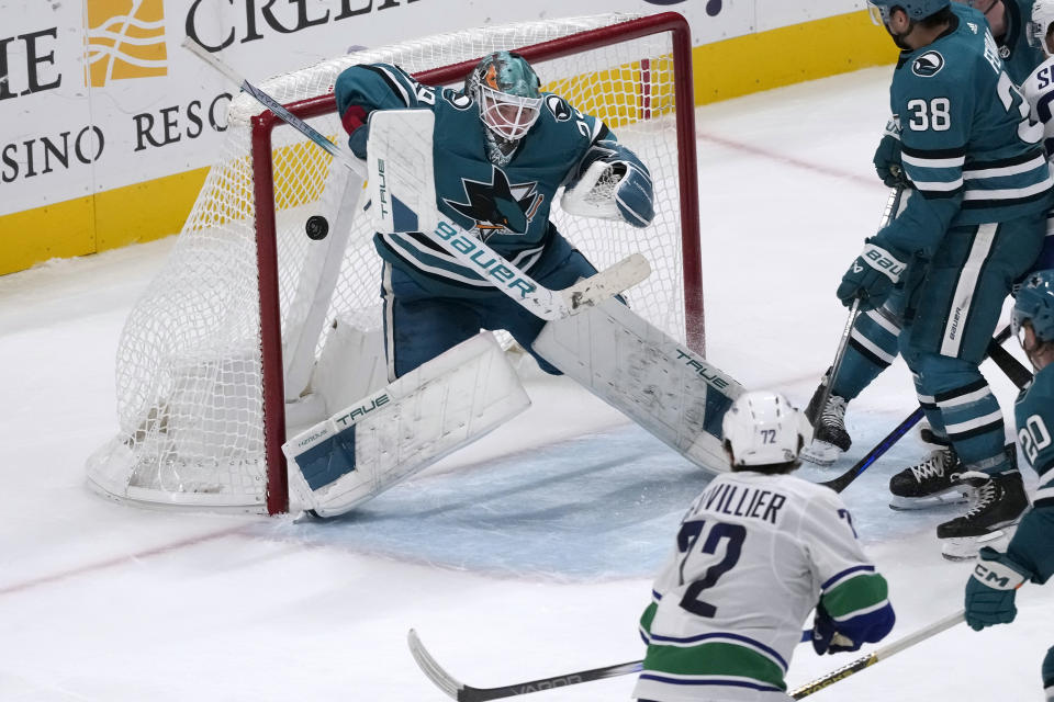 Vancouver Canucks left wing Anthony Beauvillier, bottom, scores a goal past San Jose Sharks goaltender Mackenzie Blackwood (29) during the third period of an NHL hockey game in San Jose, Calif., Thursday, Nov. 2, 2023. (AP Photo/Jeff Chiu)