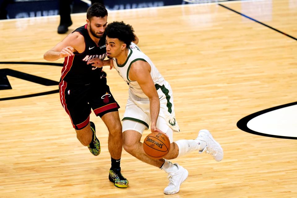 Miami Heat guard Max Strus, left, defends Milwaukee Bucks forward Jordan Nwora during the second half of a game in December, 2020.