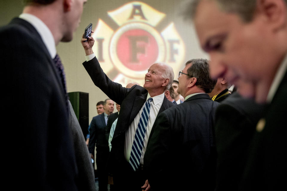 Former Vice President Joe Biden takes a photograph with members of the audience after speaking to the International Association of Firefighters at the Hyatt Regency on Capitol Hill in Washington, Tuesday, March 12, 2019, amid growing expectations he'll soon announce he's running for president. (AP Photo/Andrew Harnik)