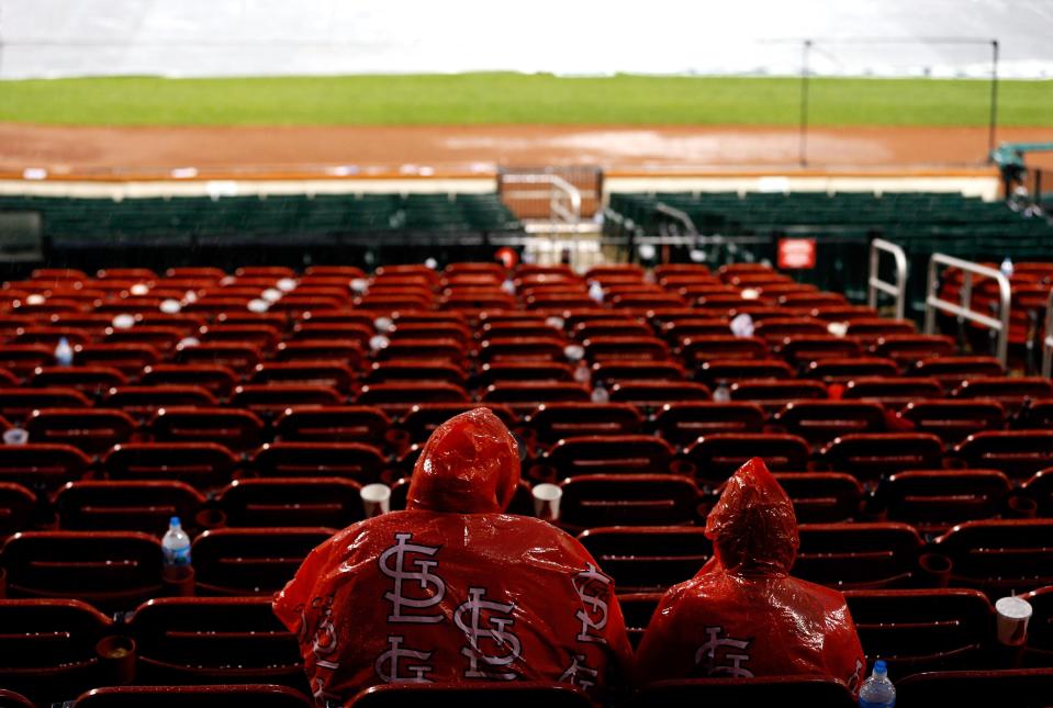 ST LOUIS, MO - OCTOBER 17: Two St. Louis Cardinals fans sit in their seats during a rain delay in the seventh inning in Game Three of the National League Championship Series between the Cardinals and the San Francisco Giants at Busch Stadium on October 17, 2012 in St Louis, Missouri. (Photo by Kevin C. Cox/Getty Images)