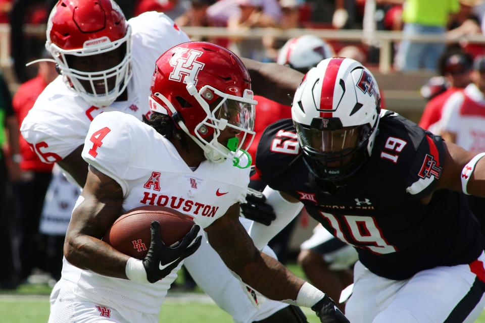 Houston running back Ta’Zawn Henry rushes against Texas Tech defensive back Tyree Wilson in the first half at Jones AT&T Stadium, Sept. 10, 2022 in Lubbock, Texas.