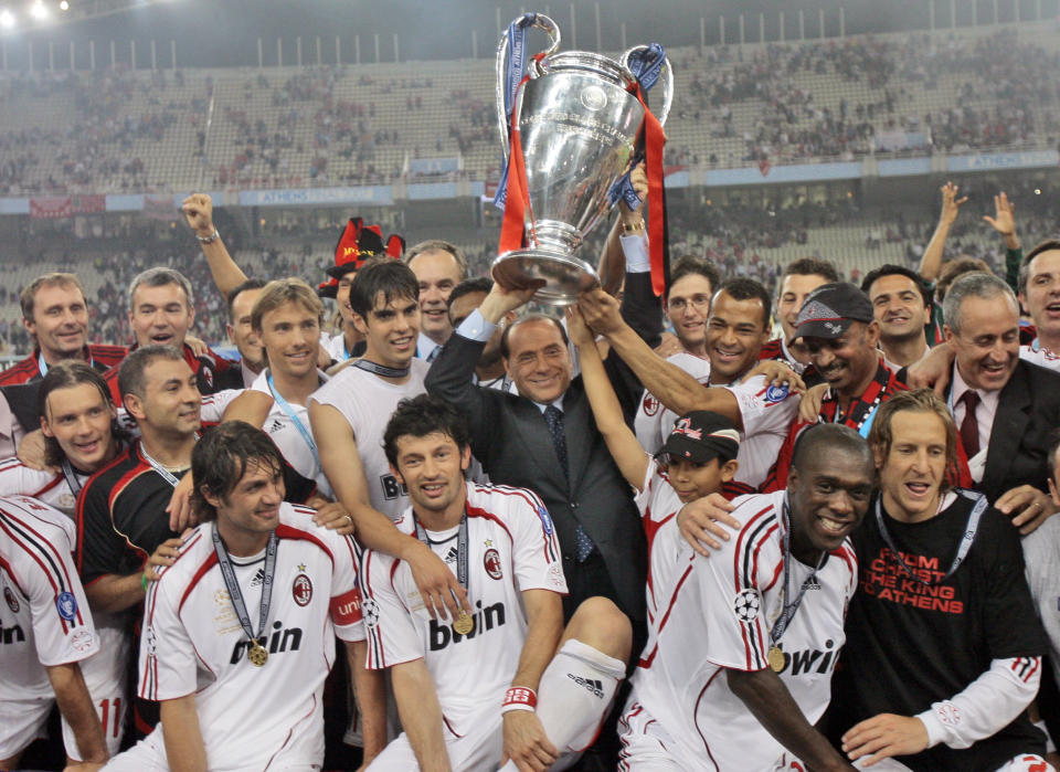 FILE - AC Milan's Silvio Berlusconi raises the trophy aloft as he stands with his team after they beat Liverpool 2-1 to win the Champions League Final soccer match between AC Milan and Liverpool at the Olympic Stadium in Athens, May 23, 2007. Berlusconi, the boastful billionaire media mogul who was Italy's longest-serving premier despite scandals over his sex-fueled parties and allegations of corruption, died, according to Italian media. He was 86. (AP Photo/Luca Bruno, File)