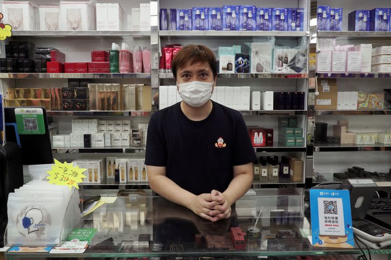 Cosmetics store owner David So poses for photo in Hong Kong's northern town of Sheung Shui