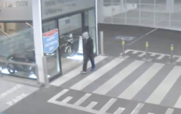 The bandit can be seen lurking around the dealership before stealing the motorbike, parked temporarily in a lift. Photo: Victoria Police