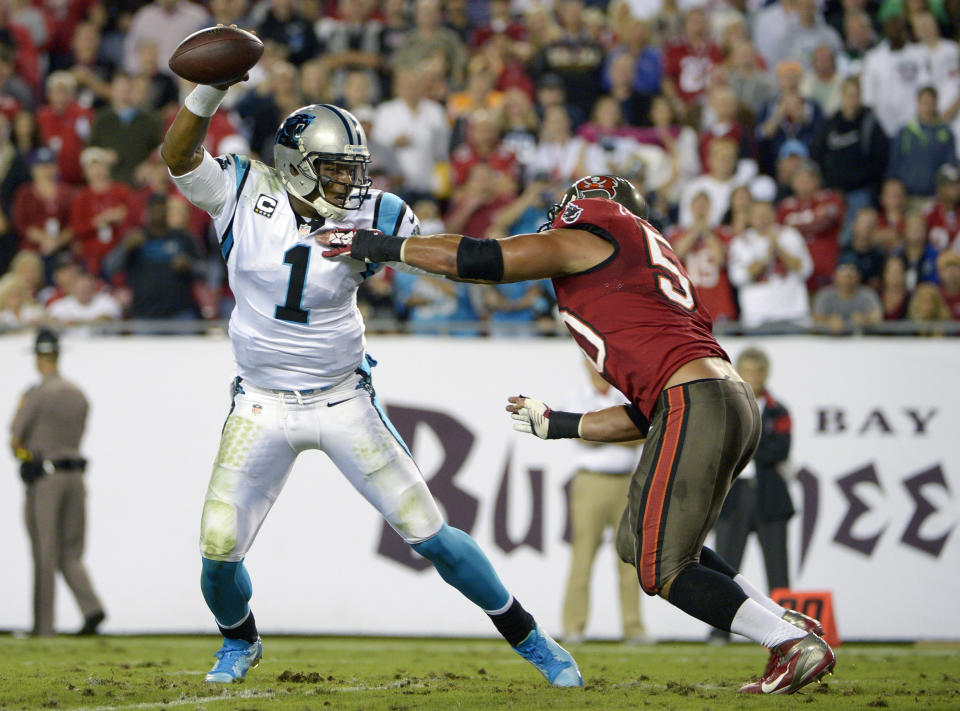 Carolina Panthers quarterback Cam Newton (1) scrambles to get away from Tampa Bay Buccaneers defensive end Daniel Te’o-Nesheim, right, during the first half of an NFL football game in Tampa, Fla., Thursday, Oct. 24, 2013. (AP Photo/Phelan M. Ebenhack)