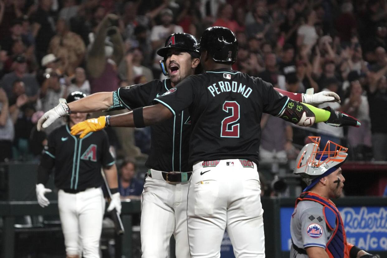 Diamondbacks outfielder Corbin Carroll celebrates with a teammate.