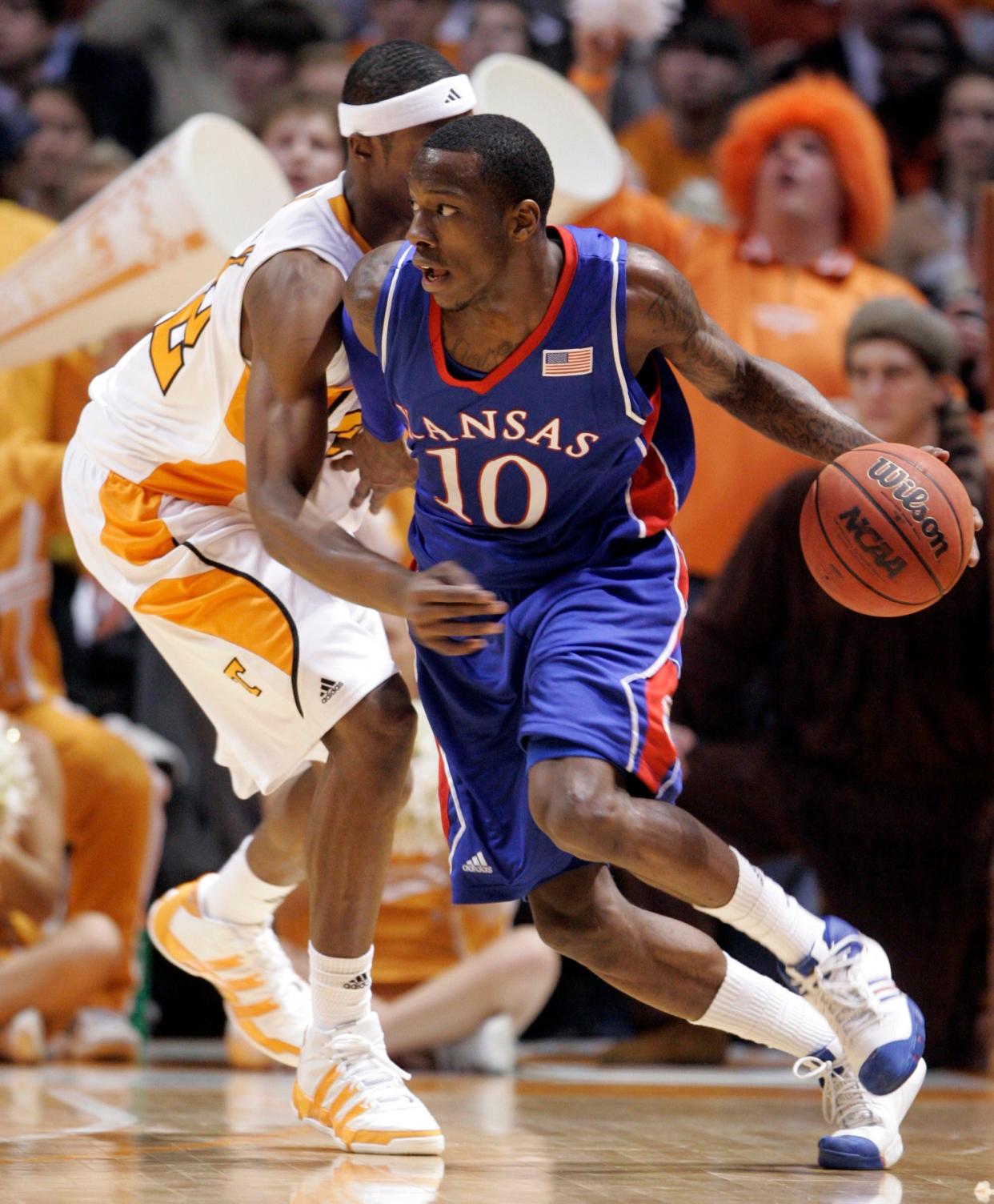 Kansas' Tyshawn Taylor (10) drives to the basket against Tennessee's Scotty Hopson (32) during the second half of an NCAA college basketball game Sunday, Jan. 10, 2010, in Knoxville, Tenn. Tennessee won 76-68.