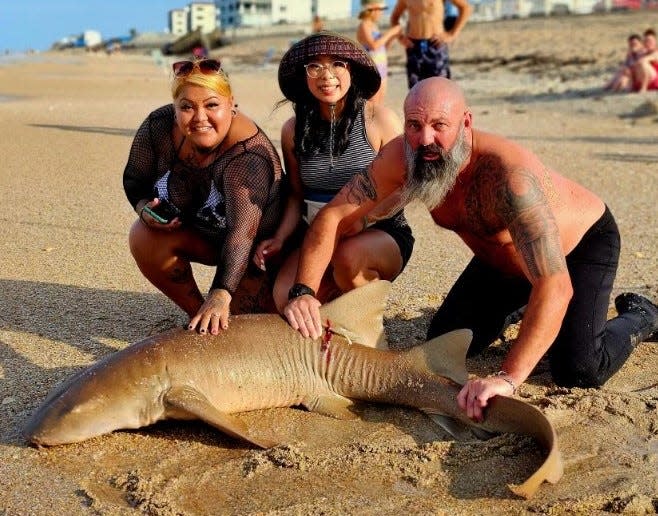 Dustin Smith (Right), of NSB Shark Hunters, helped these folks land a 75-inch nurse shark.