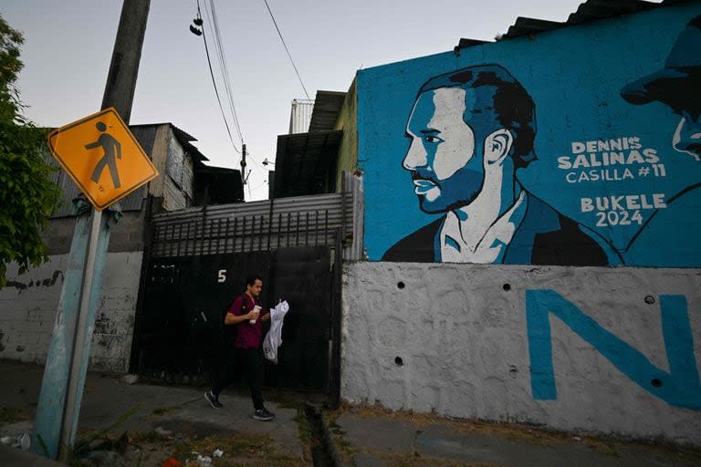 Un hombre pasa junto a un mural que representa al presidente de El Salvador y candidato a la reelección por el partido Nuevas Ideas, Nayib Bukele, en Mejicanos, San Salvador, el 1 de febrero de 2024.