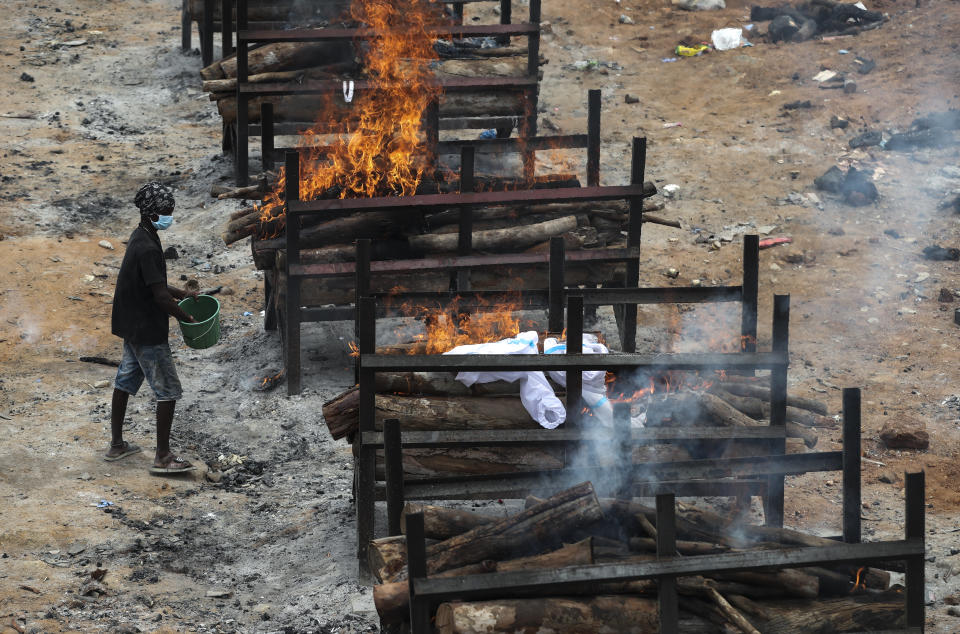 Bodies of people who died of COVID-19 are cremated at an open crematorium on the outskirts of Bengaluru, Karnataka state, India, Wednesday, May 12, 2021. (AP Photo/Aijaz Rahi)