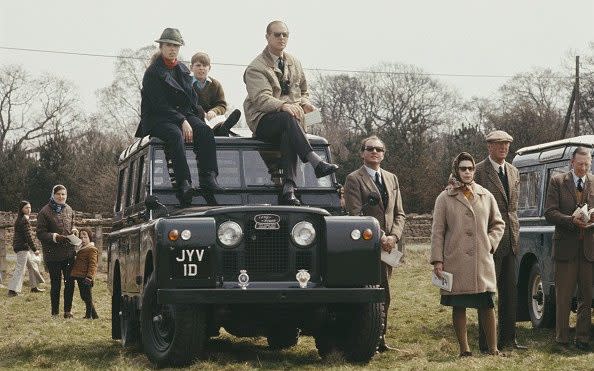 Members of the Royal family, including the Queen standing with Henry Somerset, 10th Duke of Beaufort, beside a Land Rover Series IIA station wagon with Princess Anne, Prince Philip and Prince Andrew - Popperfoto