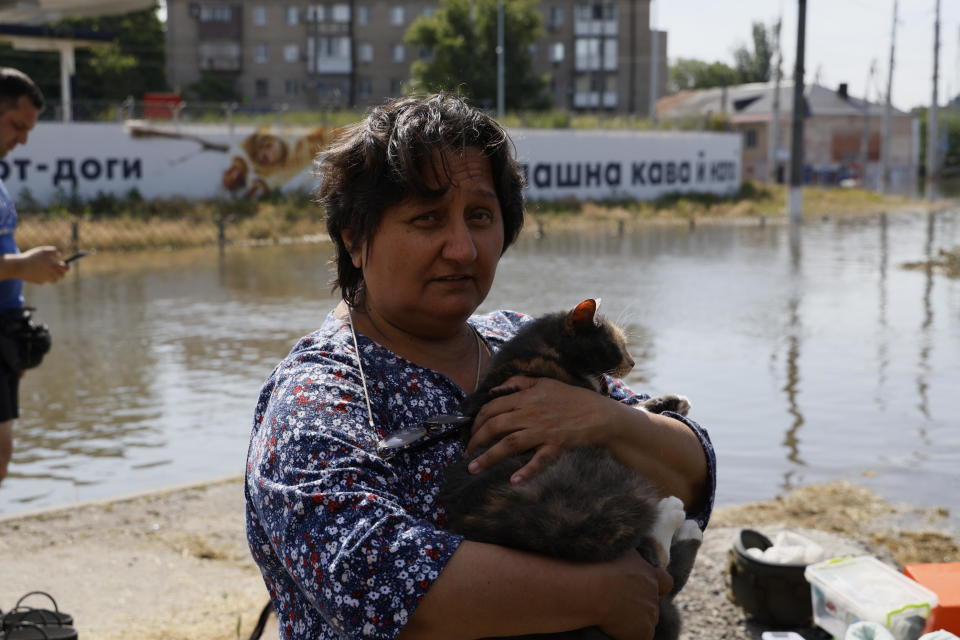 Tamila, 60 holds her cat and waits for her daughter to evacuate flooding following the destruction of the Kakhovka dam, on June 7, 2023 in Kherson, Ukraine. / Credit: Getty Images/Getty Images
