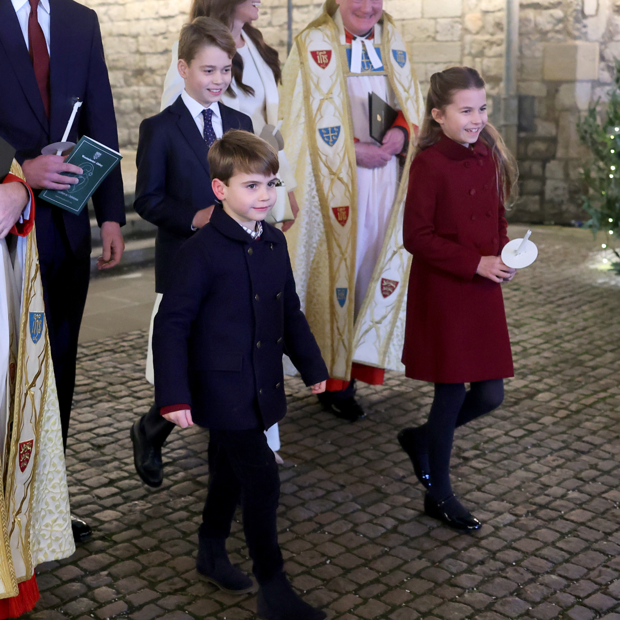  Catherine, Princess of Wales, Prince Louis of Wales, Princess Charlotte of Wales, Prince William, Prince of Wales and Prince George of Wales process out of The "Together At Christmas" Carol Service. 