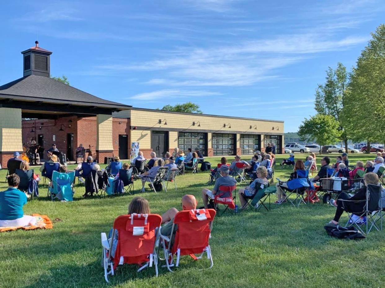People gather round to hear live music during the Boyne Area Chamber of Commerce's Pavilion Summer Music Series at the pavilion in Veterans Park. The series will again take place at the pavilion this summer.