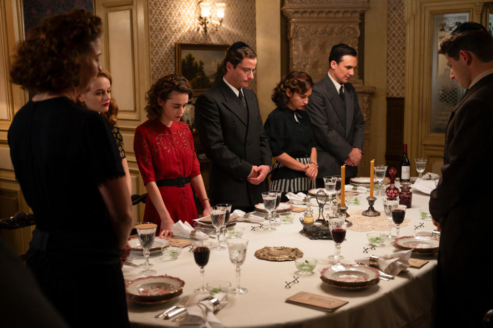 The Kurcs celebrate Passover. From left: Robin Weigert, Joey King, Hadas Yaron, Michael Aloni, Moran Rosenblatt, Henry Lloyd-Hughes, and Amit Rahav in <i>We Were the Lucky Ones</i><span class="copyright">Vlad Cioplea—Hulu</span>