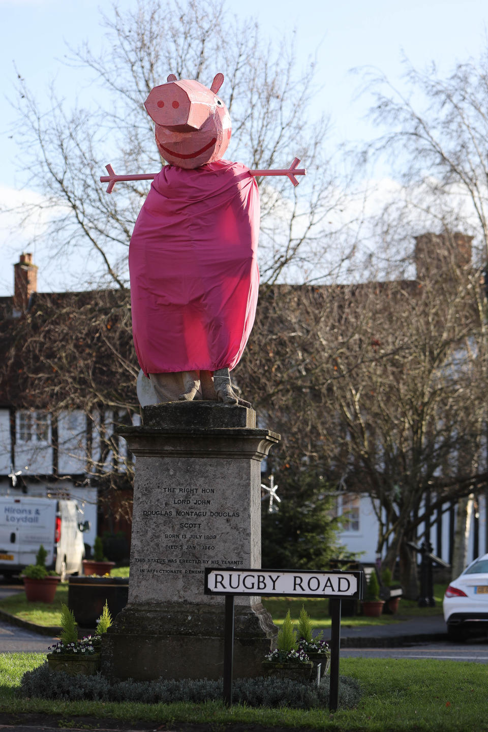 A village is hunting festive pranksters who have turned a statue of its most famous son into PEPPA PIG. The statue of Lord John Scott, who died in 1860, is a Christmas target for jokers in Dunchurch, near Rugby, Warks. Hilarious pictures show the monument draped in a pink sheet with arms stretched out and a huge pink papier mache head resembling kids' TV favourite. The statue has previously been turned into Harry Potter, Shrek, Happy Feet, Pikachu, Homer Simpson, an Olympic athlete and The Grinch in an annual tradition dating back to the 1970s.