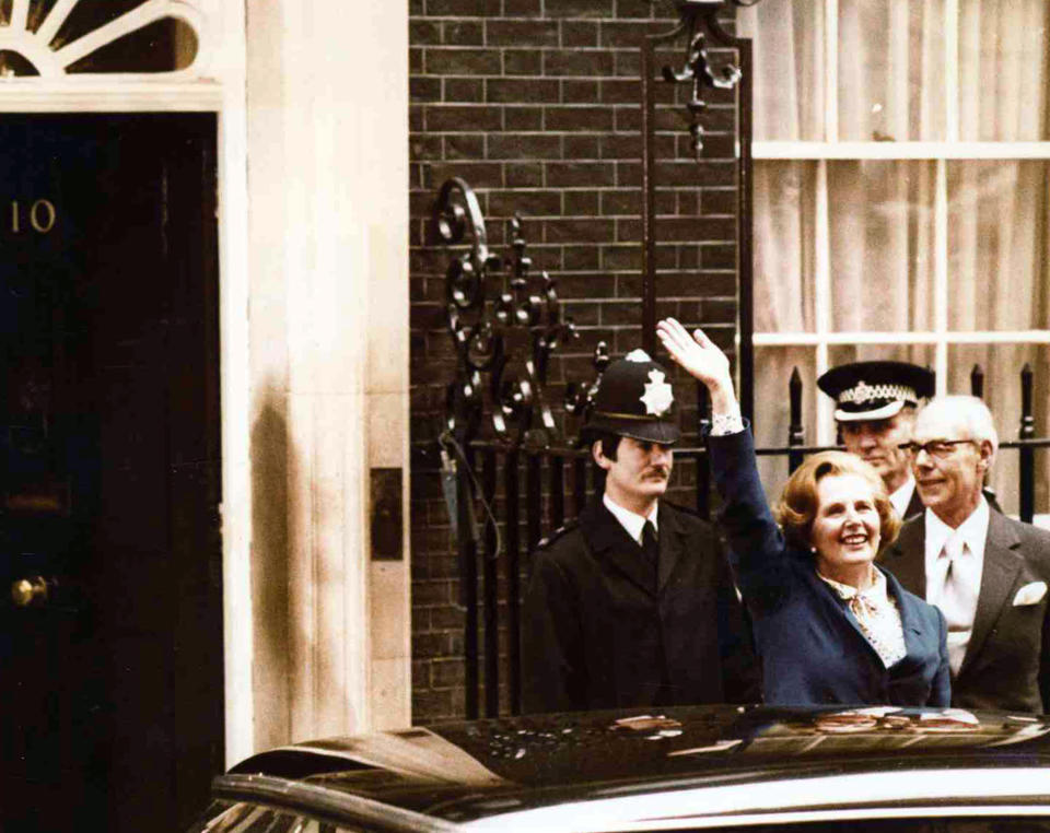 FILE - In this May 4, 1979 file photo, Britain's Conservative Party leader Margaret Thatcher waves to wellwishers as she arrives at 10 Downing Street, London with her husband Denis, right. Thatcher led her party to victory in the General Election and was asked to form a new government. Britain is facing the most testing and significant, some would say tortuous, period in its modern history since World War II. The polarized electorate now has a critical choice to make _but it seems unlikely the result, whatever it may be, will heal deep and toxic divisions that could last a generation or more. (AP Photo/Bob Dear, File)