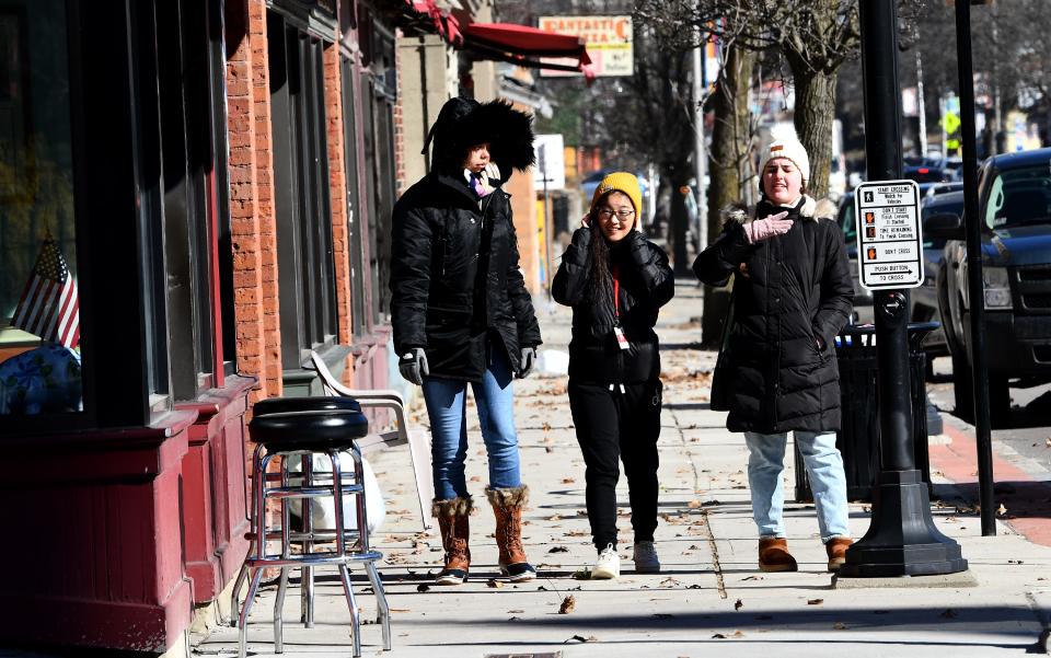 WORCESTER - Clark University students, from left, Arianna Poston of Mashpee, Muhua Wu of Medway and Amanda Crozier of Jacksonville, Florida brave the frigid cold as they walk to Annie's Clark Brunch on Friday.