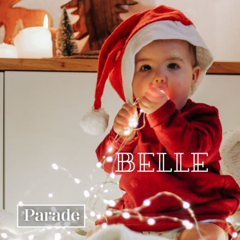 A Christmas baby holding lights.<p>Unsplash</p>