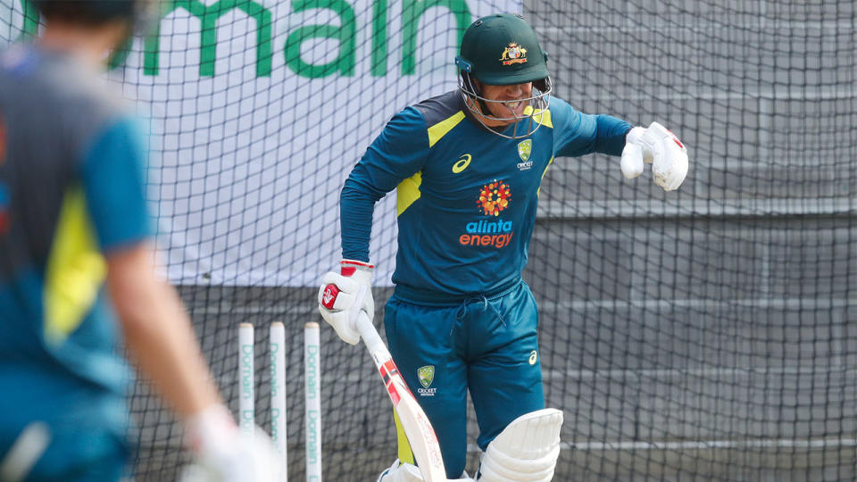 David Warner winces in pain after being struck on the hand in the nets at the MCG.