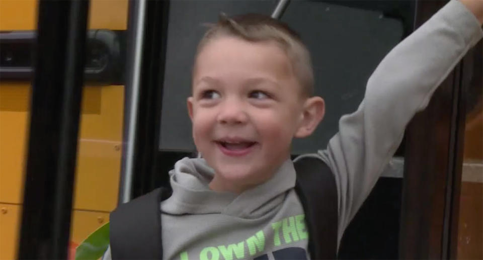 Axel is now happy and all smiles as he rides the bus to school. Source: WEAU13