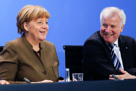 German Chancellor Angela Merkel smiles next Bavarian state premier and leader of the Christian Social Union (CSU) Horst Seehofer (R) during a news conference at the Chancellery in Berlin, Germany, April 14, 2016. REUTERS/Fabrizio Bensch/File Photo