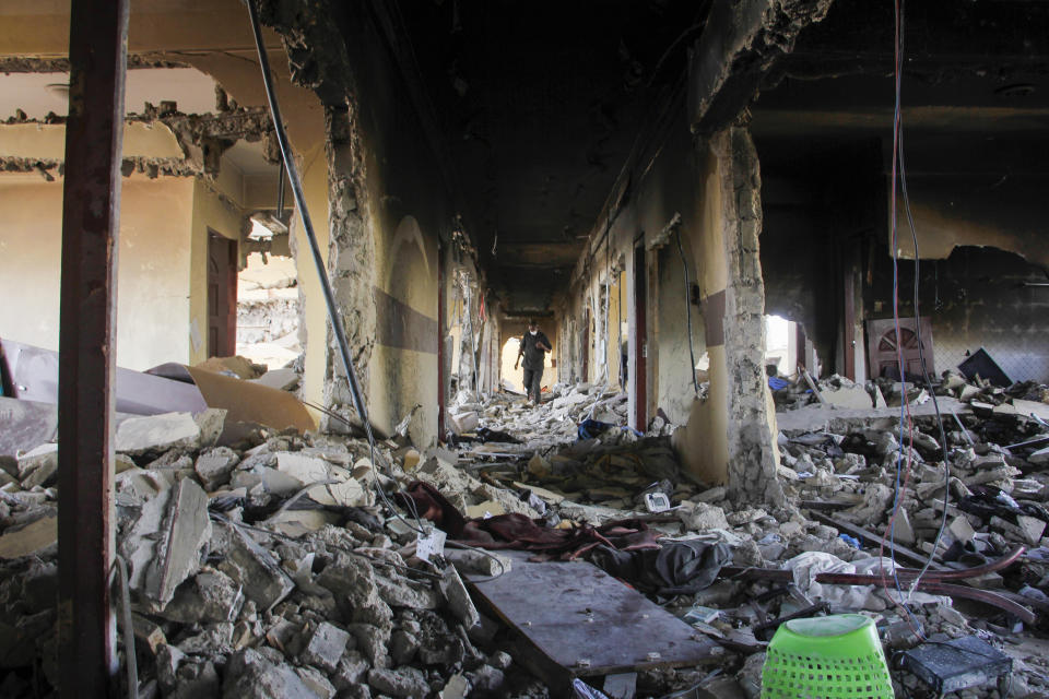 A man walks amongst debris in the destroyed Hayat Hotel, days after a deadly siege by al-Shabab extremists, in Mogadishu, Somalia Wednesday, Aug. 24, 2022. The siege was the longest such attack in the country's history taking more than 30 hours for security forces to subdue the extremists, with more than 20 people killed. (AP Photo/Farah Abdi Warsameh)