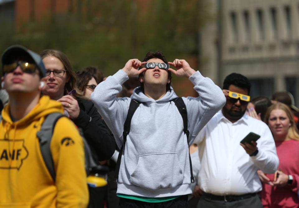 People gather to watch a partial solar eclipse Monday, April 8, 2024 at the Pentacrest in downtown Iowa City, Iowa.