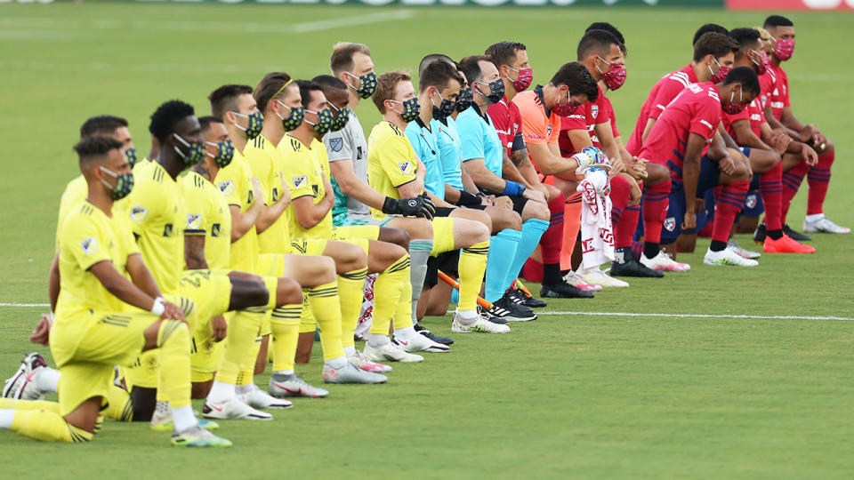 Players from FC Dallas and Nashville SC, pictured here taking a knee before their MLS clash.