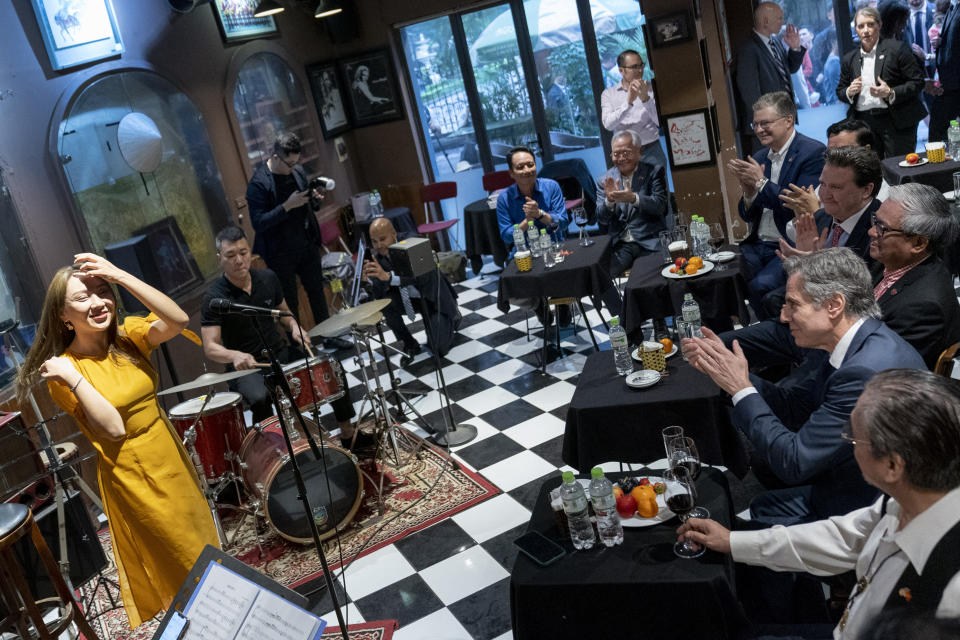U.S. Secretary of State Antony Blinken, right, accompanied by Vietnamese jazz saxophonist Quyen Van Minh, bottom right, applauds a performance at Binh Minh Jazz Club in Hanoi, Vietnam, Saturday, April 15, 2023. (AP Photo/Andrew Harnik, Pool)