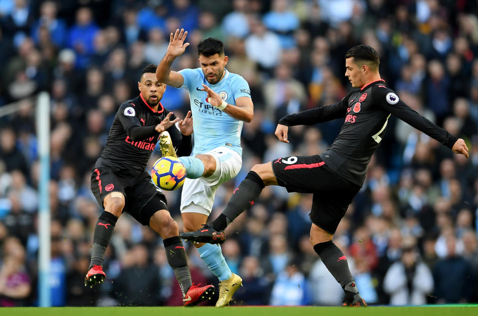 ergio Aguero of Manchester City and Granit Xhaka of Arsenal battle for possession during the Premier League match between Manchester City and Arsenal at Etihad Stadium on November 5, 2017 in Manchester, England.